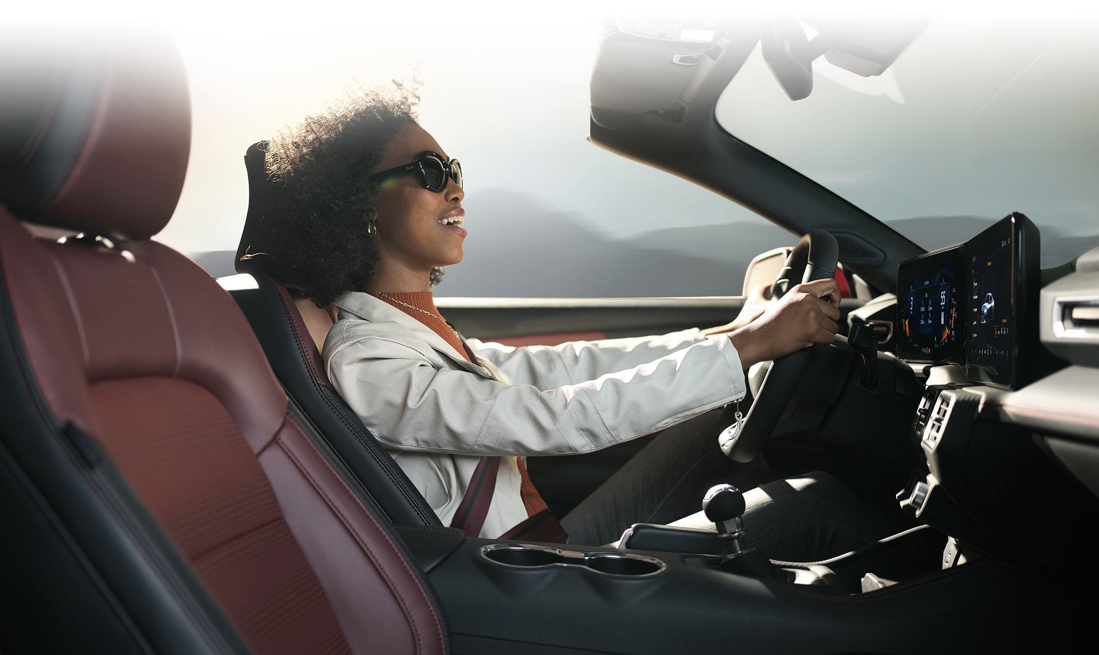 Person sitting in the driver’s seat of a 2024 Ford Mustang® convertible | Benton Ford in Benton KY