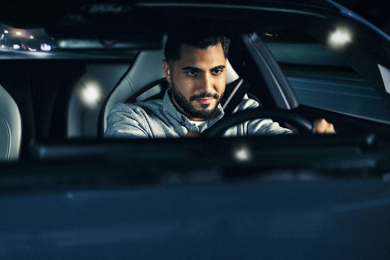 Person sitting in the driver’s seat of a parked 2024 Ford Mustang® coupe | Benton Ford in Benton KY